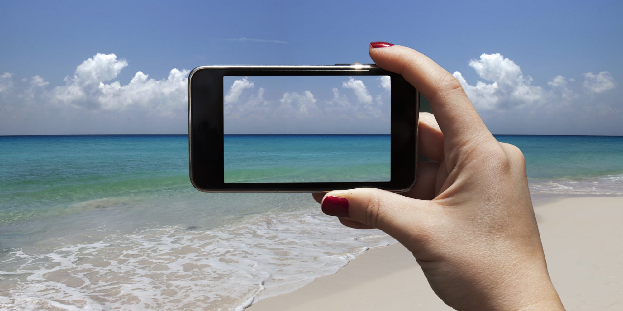 woman photographing a beach with i-phone
